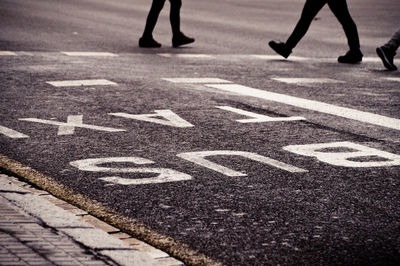 Low section of people walking on road