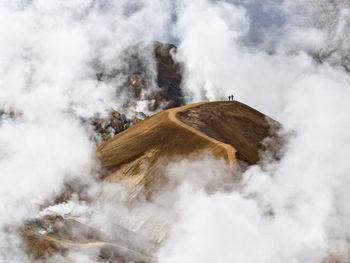 Travelers walking along mountain ridge