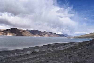 Scenic view of mountains against cloudy sky