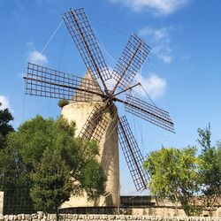 Low angle view of traditional windmill against sky