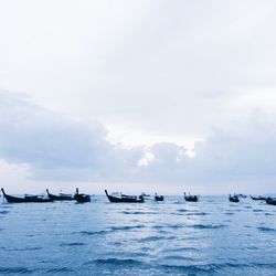 Boats in sea against sky