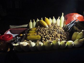 Close-up of fruits on table against black background