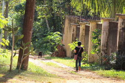 Full length of woman walking on footpath