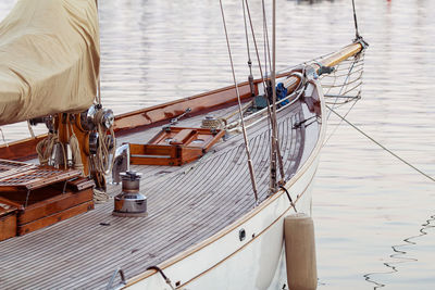 An image shows an old-fashioned yacht docked