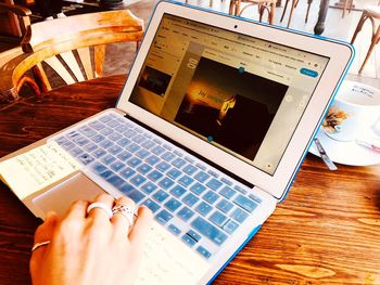 High angle view of person using laptop on table