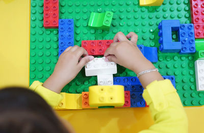 Close-up of kid playing with toys