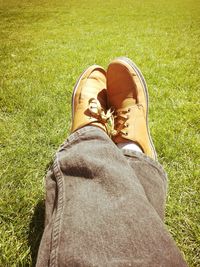 Low section of woman relaxing on field