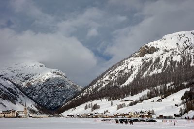 Scenic view of snow covered mountains against sky