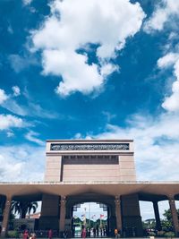 Low angle view of building against cloudy sky