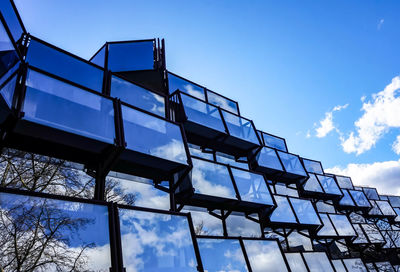 Low angle view of modern building against blue sky