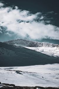 Scenic view of snow covered mountains against sky