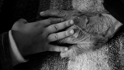 Close-up of man touching baby hand