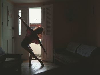 Woman holding umbrella at home