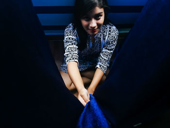 Close-up of young woman sitting on steps