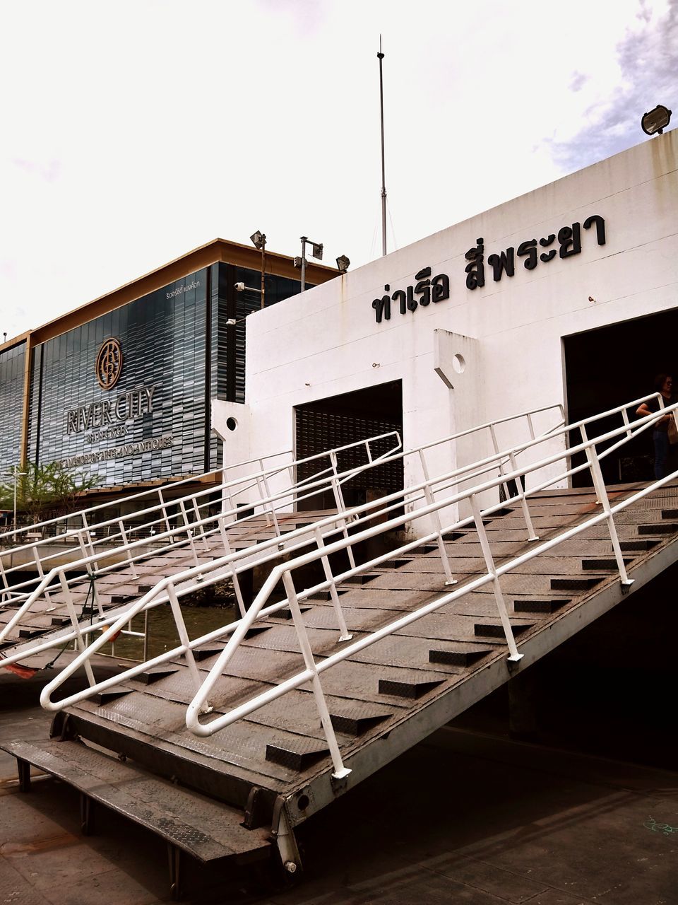 text, architecture, sky, building exterior, no people, built structure, nature, western script, communication, railing, day, outdoors, nautical vessel, clear sky, wood - material, building, staircase, transportation, white color, water