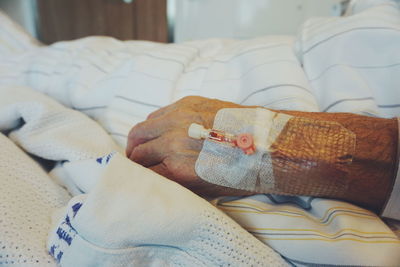 Close-up of cannulae on man hand at hospital