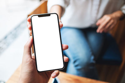 Midsection of woman using mobile phone