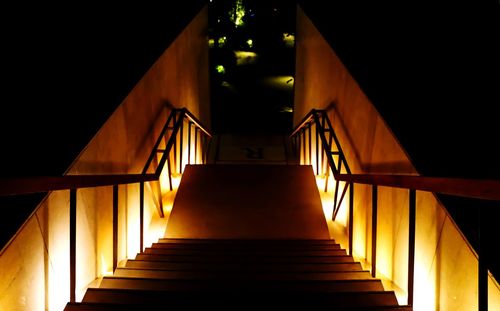 High angle view of steps amidst illuminated lights in building