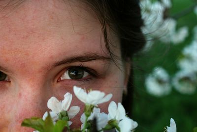 Close-up portrait of woman with red flower