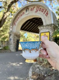 Cropped hand of woman holding coffee cup