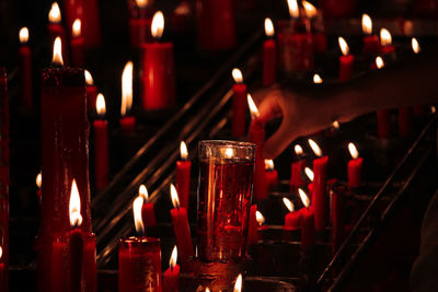 Close-up of illuminated candles in temple