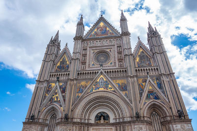 Low angle view of orvieto cathedral in italy against sky
