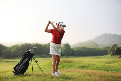 Full length of man standing on golf course