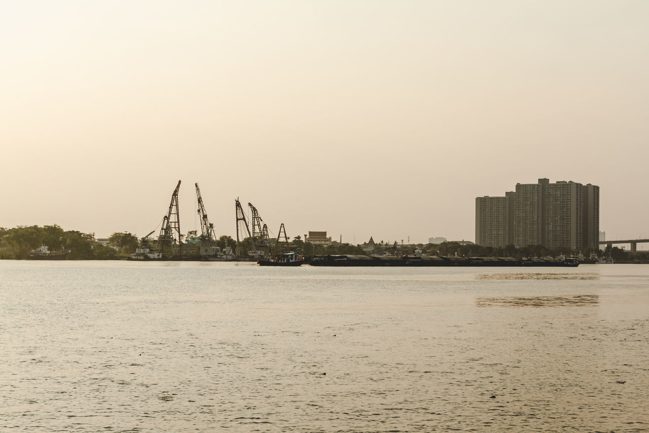 SCENIC VIEW OF SEA BY BUILDINGS AGAINST SKY