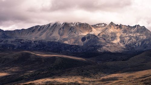 View of mountain range against cloudy sky