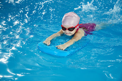 High angle view of woman swimming in sea