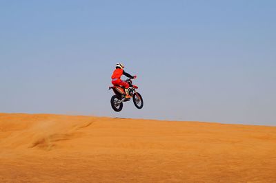 Man riding bicycle on desert