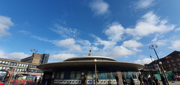 Low angle view of building against cloudy sky