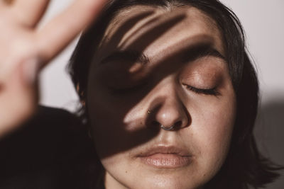 Young woman with eyes closed in studio