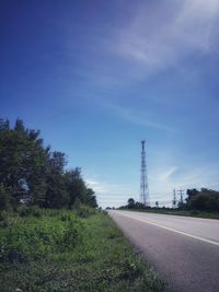 Road amidst field against sky