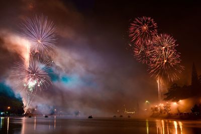 Low angle view of firework display at night