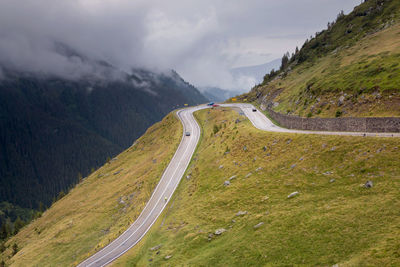 High angle view of road amidst mountains against sky