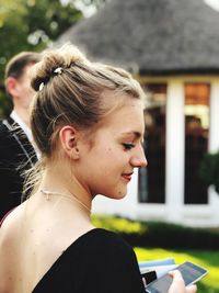 Close-up of thoughtful teenage girl standing outdoors