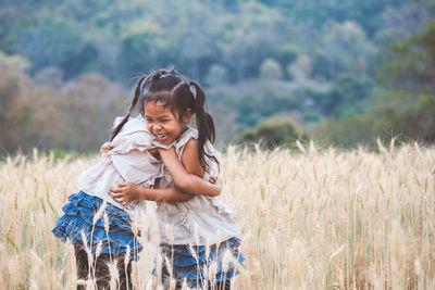 Portrait of smiling girl standing on field