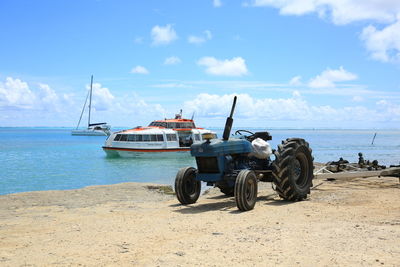 Nautical vessel on beach against sky