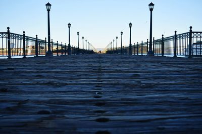 Bridge over river against sky in city