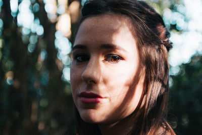 Close-up portrait of woman in forest