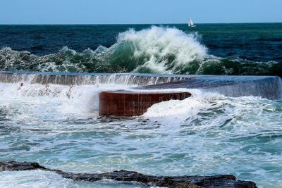 View of waves in sea against clear sky