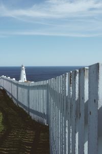 Scenic view of sea by building against sky