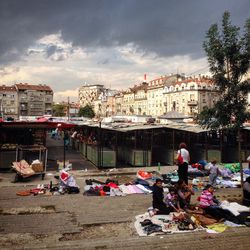 People relaxing at beach in city