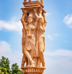 Artistic red stone jain god holy pillar at morning from unique angle
