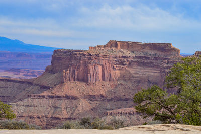 Rock formations on landscape against sky.