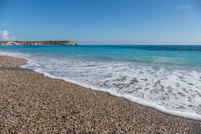 Scenic view of beach against clear blue sky