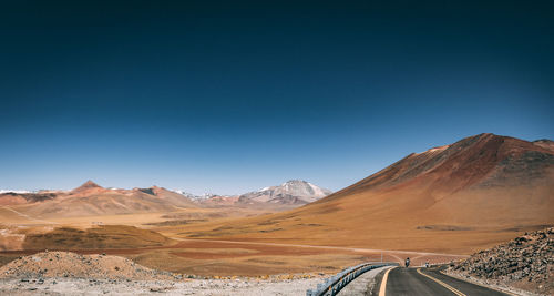 Scenic view of mountains against clear blue sky