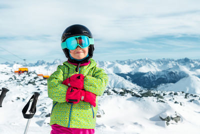 Rear view of woman standing against snowcapped mountain