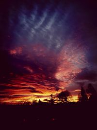 Silhouette of landscape against cloudy sky